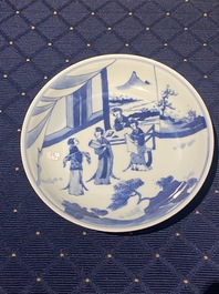 A Chinese verte biscuit figure, a green 'lotus' jar and a figurative blue and white plate, Kangxi and later